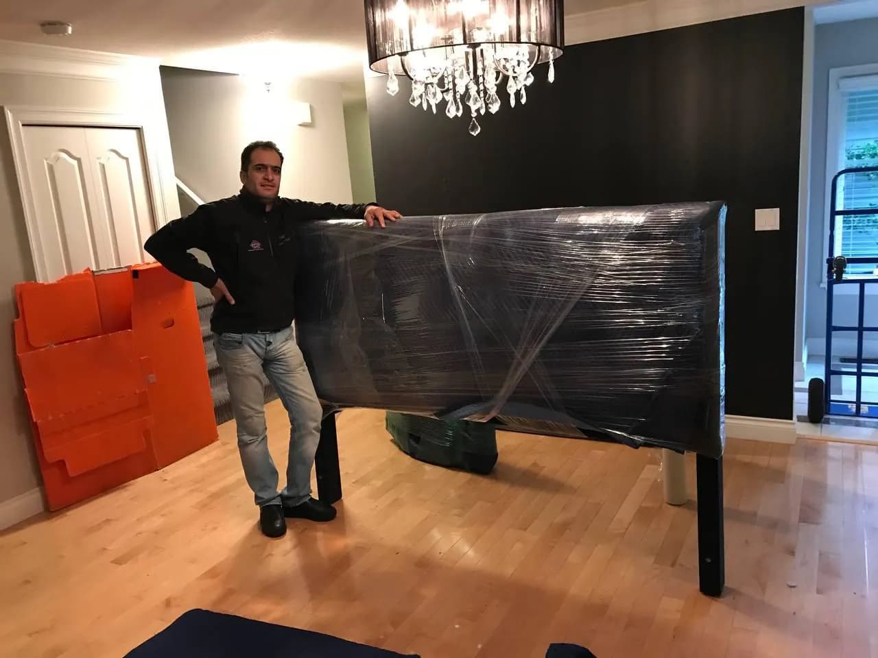 Moving team member with a protected piece of furniture