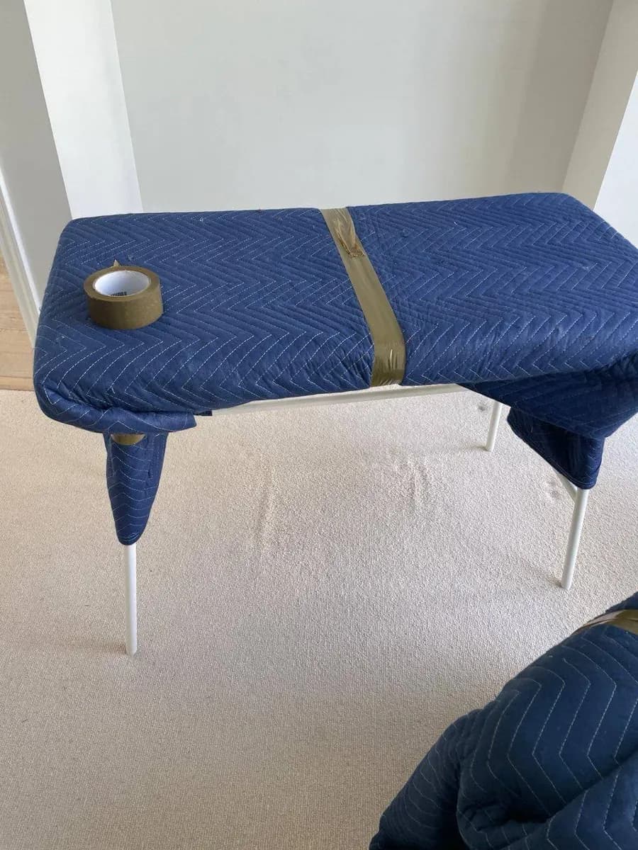 Chair covered in a protective moving blanket